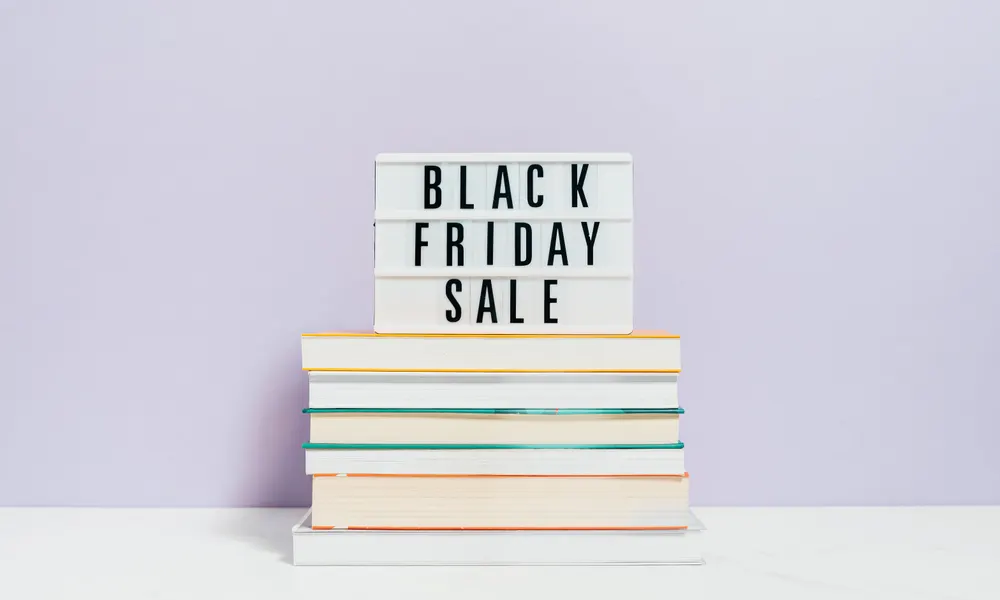 Lightbox sign reading Black Friday Sale on a stack of books